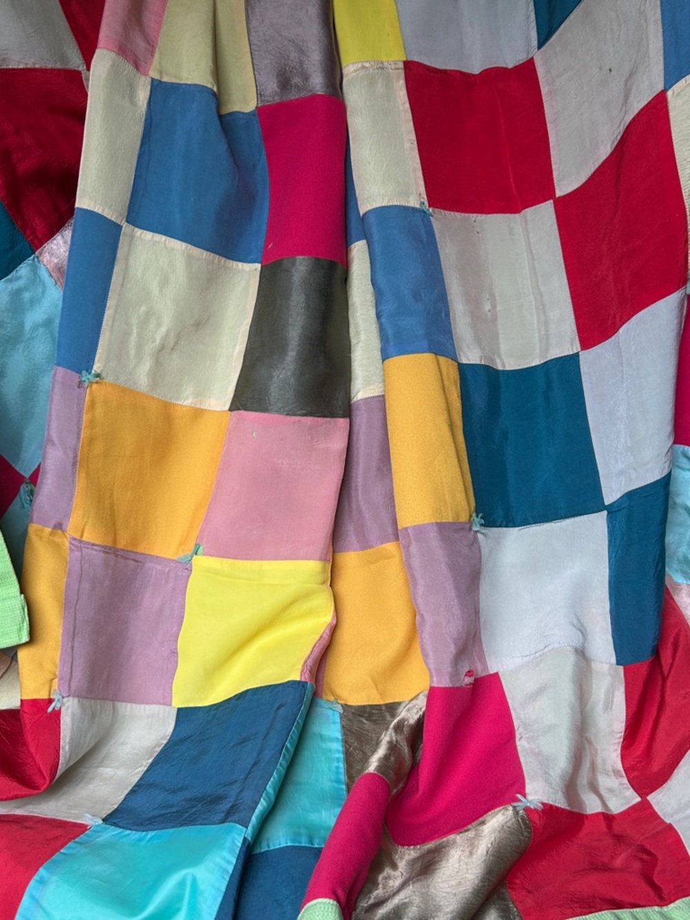 Vibrant homemade old patchwork quilt.